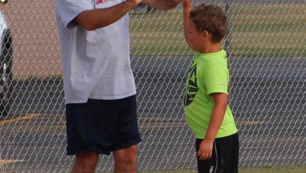 High Fives for base running Staples Motley Community Education Director Kevin Roline celebrated his first week on the job by helping at the pee wee baseball practice, giving high fives to kids learning to run the bases.