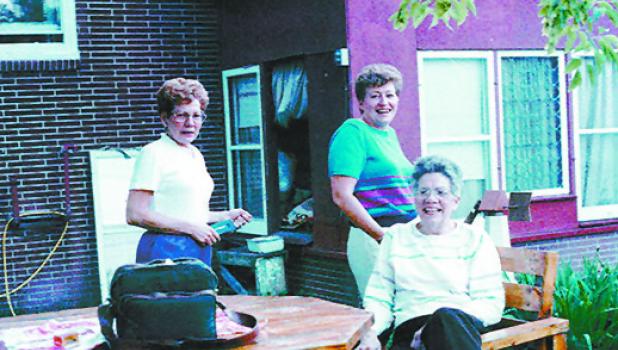 Betty Cline DeVaudruil, left, and Marge Cline Ervin, join their mother Dorothy to enjoy the yard. Behind them is the screened room where Dorothy enjoyed her antiques. (Submitted photos)