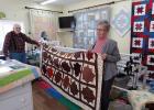 Kathy Crews of Staples holds up the ‘Autumn Leaf’ quilt she completed, made from original Jewel Tea Fabric, with her husband, Charlie Crews. The Autumn Leaf is one of the most popular vintage china patterns in America, as noted by the National Autumn Leaf Collectors Club (NALCC), of which the Crews are members. Kathy Crews’ quilt will be raffled off during the NALCC’s upcoming national convention at Ruttger’s Resort in Deerwood. (Staples World photo by Dawn Timbs)