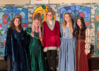 King Nathan Thelen (Staples-Motley High School Choir Director) is flocked by his four queens prior to the making of this year’s Madrigal Dinner Movie. The queens, from left, are Torii Nienow, Jadyn Kincaid, Tabetha Allen and Rose Han. The girls are seniors and members of the A Cappella Choir. The royal group is pictured near the backdrop designed by art teacher Jill Schneider. (Submitted photo)
