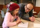 Molly Hoemberg, a fourth grader at Staples-Motley Elementary School, shows Minnesota illustrator Mike Wohnoutka some of her drawings after attending his class, ‘Create Your Own Superhero’ during the Young Writers Workshop. Hoemberg’s superhero was named Mrs. Amazing, and her sidekick was BB8. Mrs. Amazing’s nemesis was Dr. Dufus. Wohnoutka is the author and illustrator of several books; and was the illustrator of “Moo!” written by David LaRochelle, which won the Minnesota Book Award. (Staples World photos b