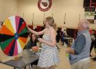 Hailey Richardt, a junior at Staples-Motley High School, spun the ‘Wheel of Fate’ during the recent Reality Store event. In back is Mythanne Thompson, volunteer at that booth. At right is volunteer Russ Holland. Approximately 175 students participated at the April 22 event, learning about budgeting money in the ‘real world.’ (Staples World photos by Dawn Timbs)