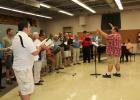 Rob Freelove (right) has been selected as the new director of the Staples Area Men’s Chorus. Here he rehearsed the chorus prior to their appearance at the Little Red Caboose Variety Show during Railroad Days. (Staples World photo by Brenda Halvorson)