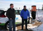 Motley Mayor Al Yoder, left; and Paul Helstrom with Minnesota Power in Duluth, spoke following a ribbon-cutting event at the new solar-powered electric vehicle (EV) charging station in Motley. Helstrom, who was charging the Chevrolet Bolt he drove to Motley from Duluth (in background) took time to answer questions pertaining to electric vehicles. The charging station in Motley is located near the intersection of Highways 10 and 210, on property near BRICKS which the city is leasing. (Staples World photo by 