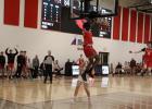 The Staples-Motley boys basketball team gets up to cheer during the game against Royalton, as Avandre Brand slame a basket through the hoop on a fast break. The Cardinals won four games last week, see story on page 11 a.