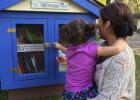 Maria Wolfe and her daughter Natalie of Brainerd  stopped by the Little Free Library in rural Motley recently.  It is located in Scandia Valley Township, near Maria Wolfe’s parents’ home (Bob and Carolyn Lohman) on West Shamineau Dr. (Submitted photo)