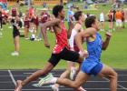 Avandre Brandt bursts between the two leaders halfway through the 200 meter dash, before catching them by the finish line. (Staples World photos by Mark Anderson)