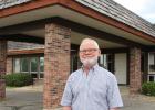 Just a week after retiring, Dr. William Mennis stands in front of the clinic building that his medical practice built in 1969, now Staples Family Dentistry. After the clinic merged with Lakewood Health System and is expanding again, he said “It grew into something nobody could have ever imagined.”
