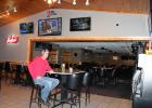 John Brichacek, owner of 2 Tall Tavern in Cushing (the former Hitchin Rail), is pictured at one of the granite-top tables in the remodeled bar and grill he opened Nov. 1. Brichacek has worked a variety of construction jobs over the years, but said it had been his dream for quite some time to own his own bar/restaurant. When he learned that The Hitchin Rail was for sale, he decided to make his long-time dream a reality. (Staples World photo by Dawn Timbs)