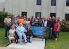 Several staff members at Central Lakes College attended a bench dedication for their fellow colleague Vickie O’Brien who passed away unexpectedly in June of 2023. O’Brien was a nursing instructor at CLC. Pictured in front, from left, are Vickie’s daughter Katya O’Brien, Alexandria; her best friend and fellow (retired) nursing instructor Karen Treangen, Hewitt; and Vickie’s daughter Randee O’Brien, Buhl, Idaho. The bench was made by Randee’s boyfriend, Alex Wagner of Buhl; and powder-coated by their friend, 