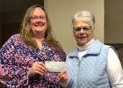 Stephanie Leslie (left), a member of the Piecemakers Quilt Club, presents a check for $100 to Sherry Miller Frisk of the Motley Area Food Shelf. (Submitted photo)