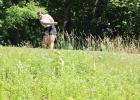 Adriana Dickey tees off from the top of a hill during the state golf tournament at Sand Creek in Jordan. (Staples World photo by Mark Anderson)
