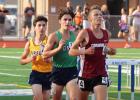 Emmet Anderson glances up at the scoreboard clock to check his split time, as he is trailed by Geno Uhrbom and Alden Keller. (Staples World photo by Mark Anderson)
