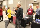 Above, the three Staples-Motley school principals talk with prospective teachers and staff from neighboring districts at Sourcewell in Staples. They are Kathy Johnson (in background), John Regan (center) and Mike Schmidt (second from right).