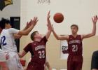 Ben Olander and Izaiah DeMars corral a rebound. (Staples World photo by Mark Anderson)