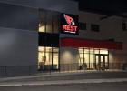 An even bigger sign announces The NEST on the south side of the newly renovated gymnasium. Finishing touches are being made to the entrance of The NEST on 3rd Street NE, which will become the varsity gym, formerly called the South Gym. A lighted sign is above the entrance, with a view to the second floor walking track. Also going up in the entry way are trophy cases and Staples-Motley Athletic Hall of Fame memorabilia.