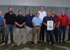 Celebrating the MDA Water Certification of R.D. Offut’s Twin Rivers Farm in Staples, from left, Ken Heintzeman (Office of Congressman Pete Stauber), Ben Anderson (Office of Congresswoman Michelle Fischbach), Rep. Josh Heintzeman (R-Nisswa), MDA Commissioner Thom Petersen, Staples Mayor Ron Murray, Sen. Paul Utke (R-Park Rapids), Jake Jacobson (RDO Staples Farm Manager, holding sign), Rep. Mike Wiener (R-Long Prairie), Jim Lahn (MDA Ag Water Quality Program Evaluator), Warren Warmbold (RDO VP of Operations).