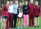 The Staples-Motley girls cross country team with their championship trophy after winning their conference race on Oct. 10. From left, Tayler Yungbauer, Natalie Kleiberova, Kaitlin Smith, Kira Sweeney, Ameara Chenoweth, Addison Lorber and Mackenzie Wilds. (Staples World photo by Mark Anderson)