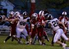 The line clears a hole for running back Tristan Moore. (Staples World photos by Mark Anderson)