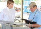 Samuel Sauber with chicken judge Vern Holtzheuter.